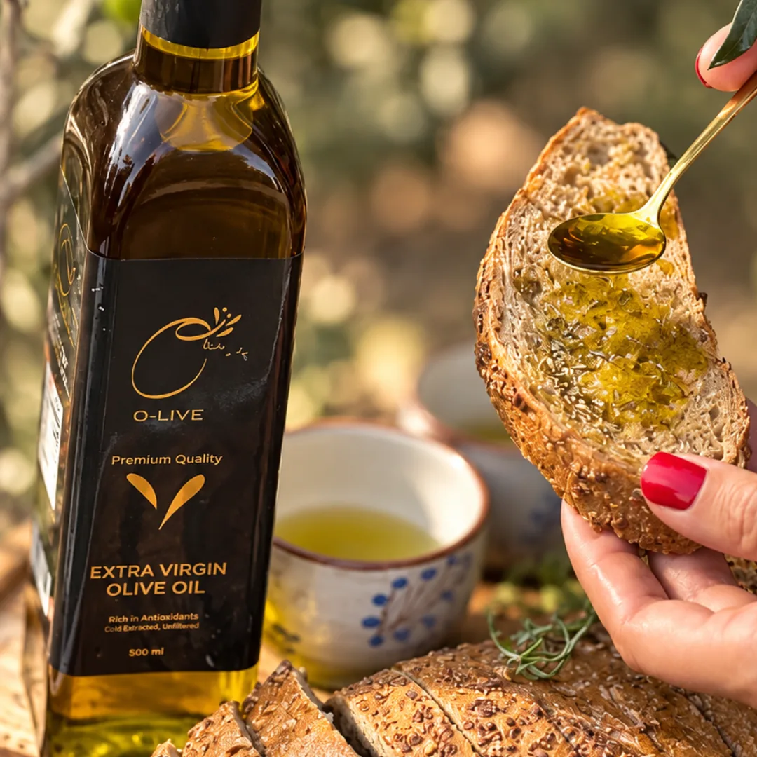 A spoon of O-Live oil drizzled over a slice of bread